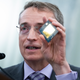 Intel CEO Pat Gelsinger holding up a microchip